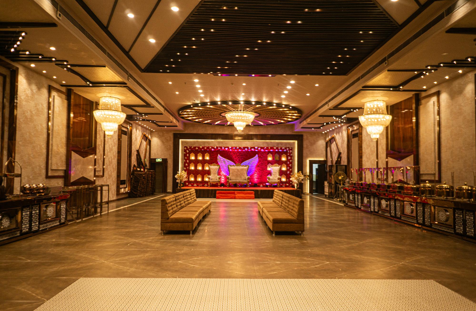 Close-up of ornate crystal chandelier illuminating the banquet ceiling at Swayamvar Banquets, Kolkata
