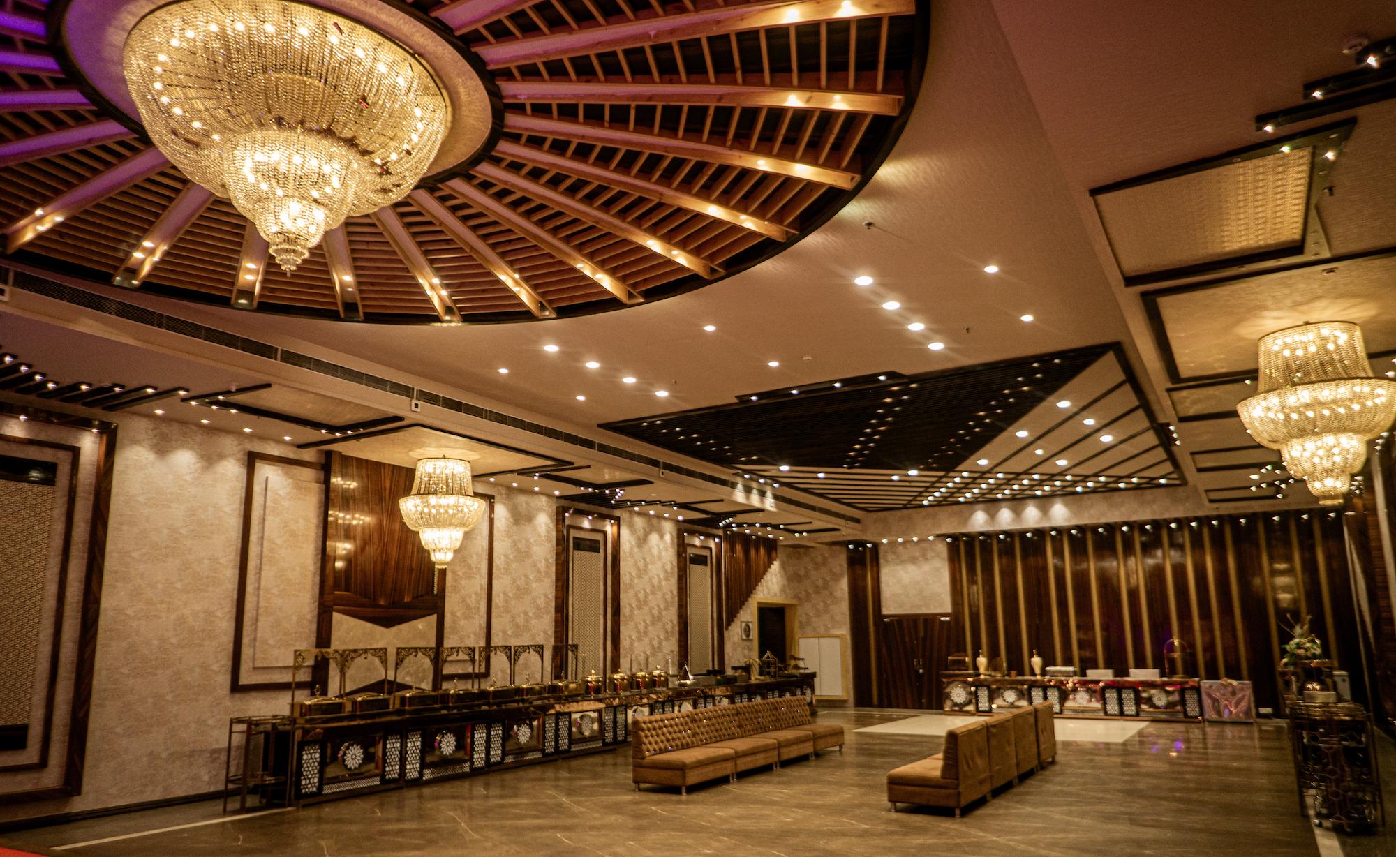 Wide shot of decorated wedding stage with seating arrangement at Swayamvar Banquets banquet hall