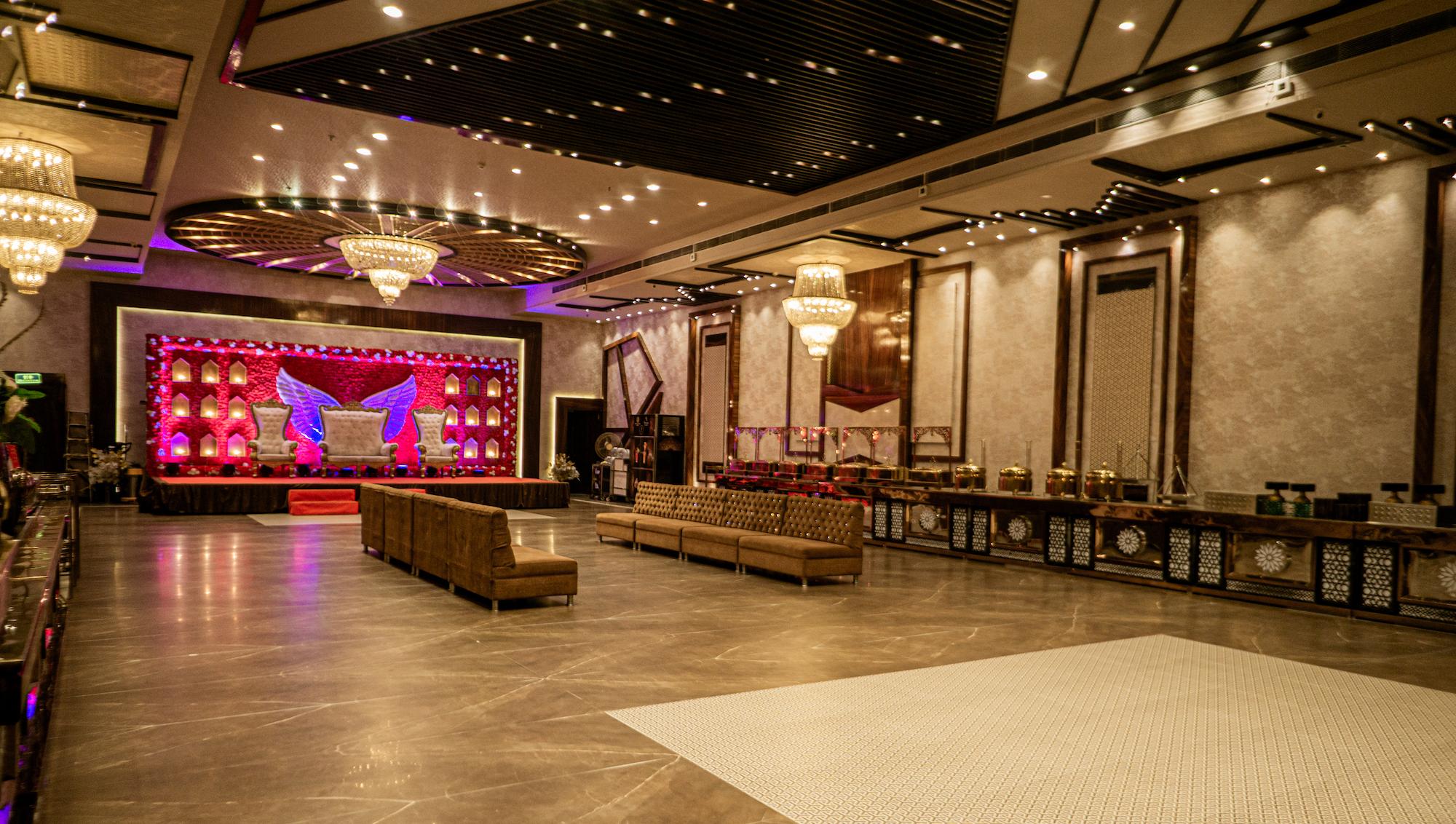 Decorated stage with floral arrangements and ambient lighting for wedding ceremonies at Swayamvar Banquets, Kolkata